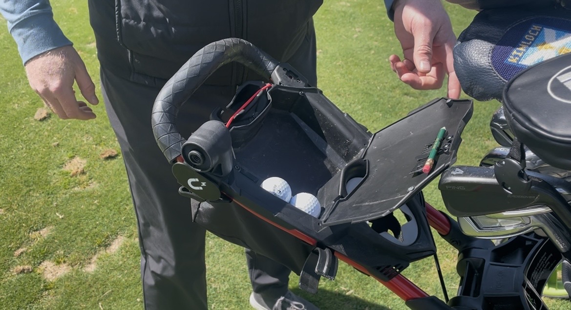 Bag Boy Nitron scorecard console opened to show golf ball storage